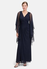 Abito da sera blu navy con design a portafoglio e maniche leggere e fluide. Presenta un corpino aderente con una morbida texture e una gonna fluida.
