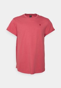 T-shirt à manches courtes col rond de couleur corail, en coton, avec un petit logo sur la poitrine, léger et coupe décontractée.