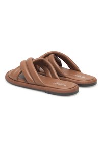 Des sandales en cuir marron avec trois sangles courbées, des semelles plates et un coussin de pied rembourré. La base en caoutchouc assure flexibilité et confort.