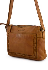 Tan leather shoulder bag with a woven pattern on one side, zip closure, and adjustable strap. Features branding on the front.
