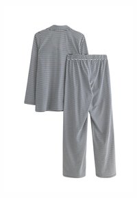Set di pigiama a righe in navy e bianco. La maglia presenta maniche lunghe con colletto; i pantaloni hanno un elastico in vita. Realizzato in tessuto morbido e leggero.