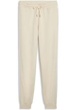 Pantalones deportivos beige con cintura elástica, cordón ajustable, bolsillos laterales, franjas laterales y un pequeño logo en la parte superior de la pierna izquierda.