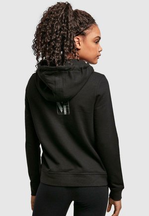 Black hoodie with a drawstring hood, featuring a subtle logo on the back. Made from soft fabric, with ribbed cuffs and hem.