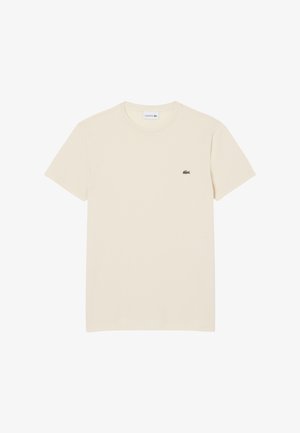 T-shirt a maniche corte con scollo rotondo in cotone avorio, con un piccolo logo coccodrillo verde Lacoste sul lato sinistro del petto.