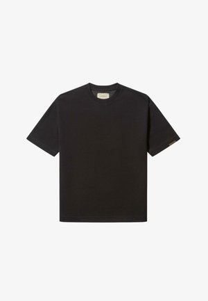 Black cotton t-shirt with short sleeves, crew neckline, and subtle branding label on the left sleeve. Smooth texture and relaxed fit.