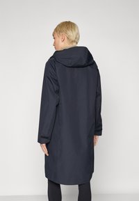 Navy raincoat with a relaxed fit, hood, and long sleeves. Smooth texture with adjustable cuffs, falling just below the knee.