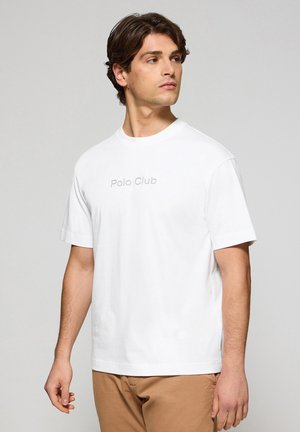 White cotton t-shirt featuring short sleeves and a crew neck, with the text "Polo Club" printed in light gray across the chest.