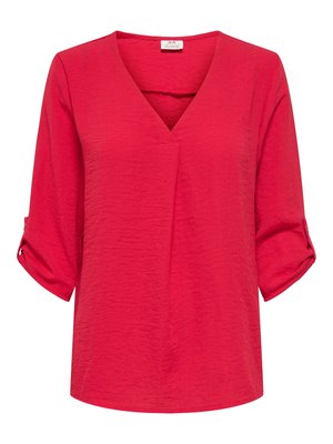 Raudona, lengva palaidinė su V formos iškirpte, trijų ketvirčių rankovėmis ir susuktais apvadais. Tekstūruotos medžiagos, laisvo silueto ir tiesios apačios.