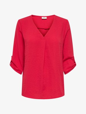 Punane, kerge pluus V-kaelusega, kolmeveerand varrukate ja rullitud mansettidega. Tekstuuriga kangas, lõdva istuvusega ja sirge äärega.