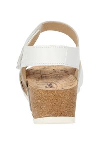 Sandalo bianco in pelle con soletta in sughero e tacco spesso. Presenta un cinturino regolabile e una superficie liscia. Design classico con apertura sul dietro.
