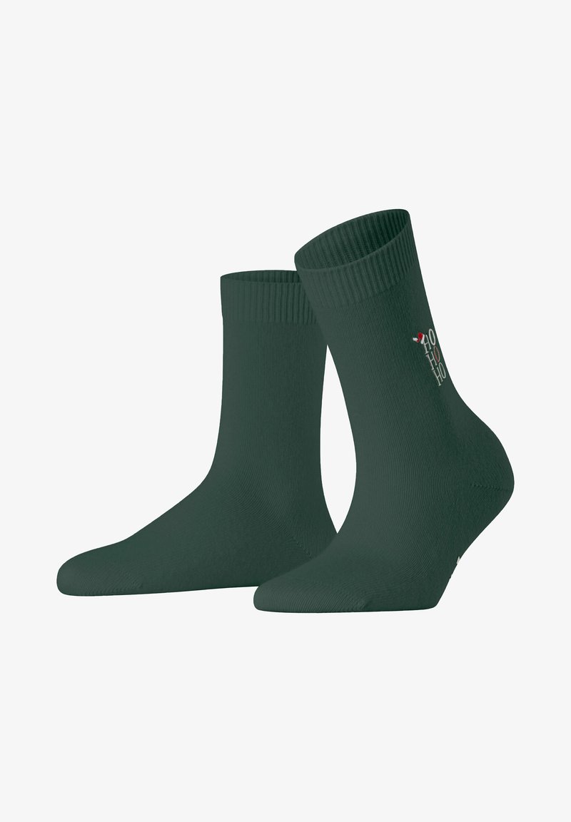 Chaussettes en coton vert avec un haut côtelé, présentant une texture lisse et un petit motif "HO HO HO" sur le côté. Longueur mi-mollet.