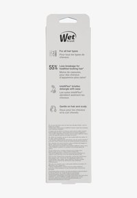 Witte verpakking voor Wet Brush bevat instructies in meerdere talen en benadrukt voordelen zoals vermindering van haarbreuk en IntelliFlex borstelharen.