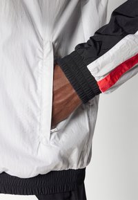 Under Armour ICON TRACK - Training jacket - white/black