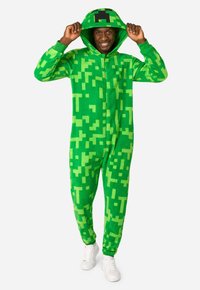 Green onesie made of soft fabric featuring a pixelated design. Includes a hood with a block motif and front zipper.