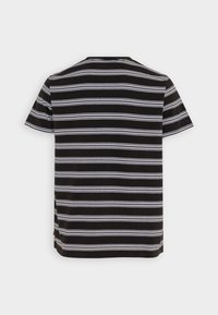 T-shirt noir à manches courtes avec des rayures blanches horizontales. Encolure ronde avec un ourlet droit. Le tissu a une texture lisse.