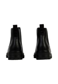 Zwarte enkellaarsjes van gladleer met trekflappen, een gestructureerde rubberen zool en een ronde teenzool.