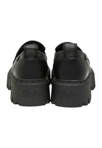 Černé platformové boty s robustní texturovanou podrážkou a hladkým koženým svrškem. Vybavené polstrovaným límcem a embosovaným logem značky na patě.