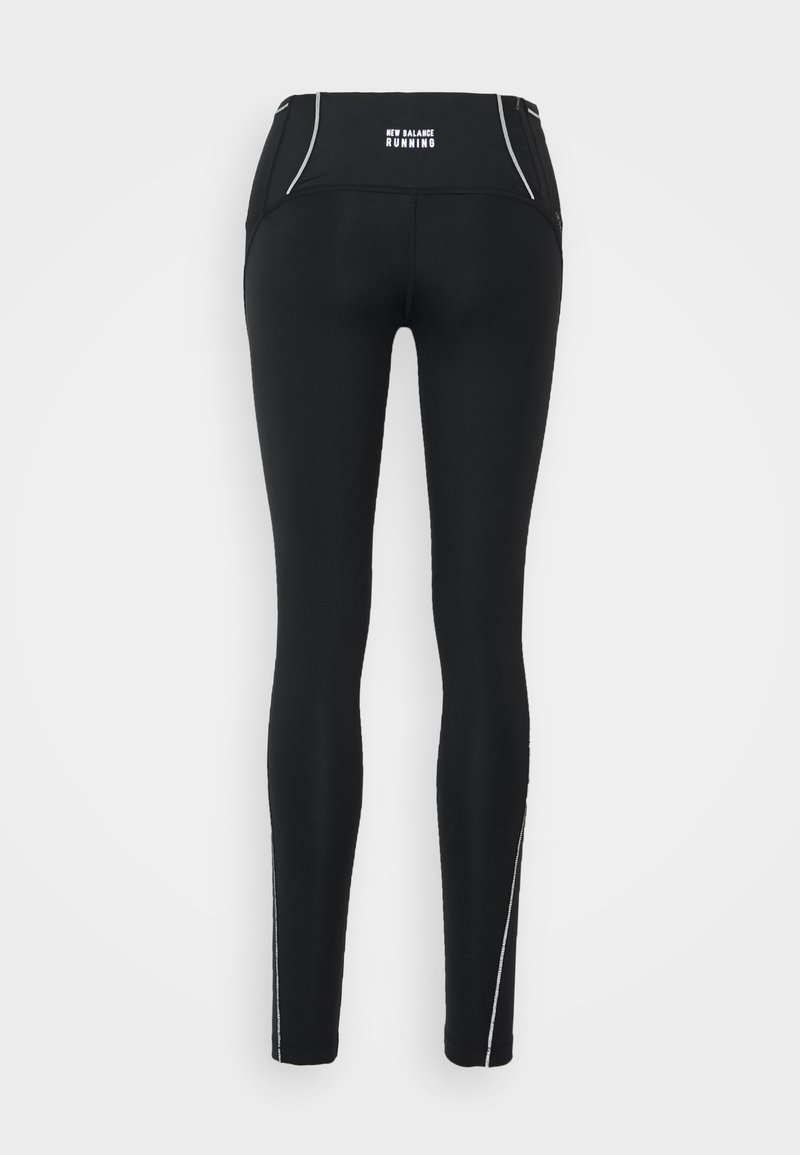 Leggings de course noires avec une taille haute, dotés d'accents réfléchissants et d'un tissu lisse et extensible pour la flexibilité et le confort.