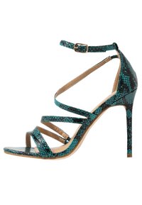 Korkokenkä, jossa on turkoosit käärmeennahkakuosiset hihnat, avonainen kärki ja nilkkasulu. Sisäpuolella on beige vuori ja hoikka korokepohja.