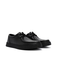 Zwarte leren schoenen met een rond neu, voorzien van veters en een gestructureerde afwerking. De zool is iets verhoogd met een ribbelpatroon.