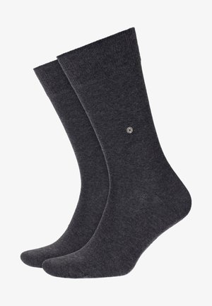 Calzini di cotone grigio scuro con una texture liscia, bordo a coste e un piccolo logo circolare su un lato. Lunghezza classica a metà polpaccio.