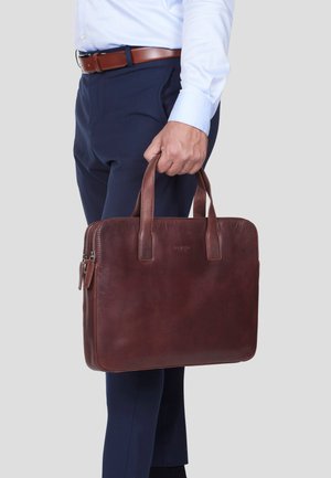 Brown leather briefcase with two top handles, zip closure, and subtle branding. Smooth texture and rectangular shape.