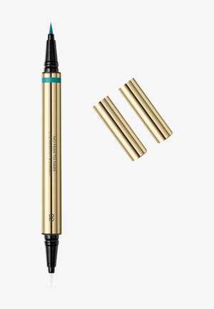 Stylo eyeliner et mascara double embouts doré avec embout turquoise d'un côté et embout noir de l'autre, avec deux bouchons dorés retirés et placés à proximité.