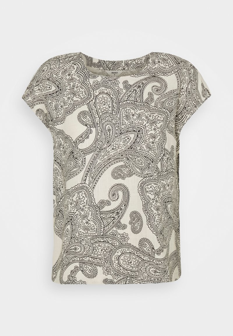 Blouse beige à manches courtes avec un motif cachemire noir complexe et un col rond.