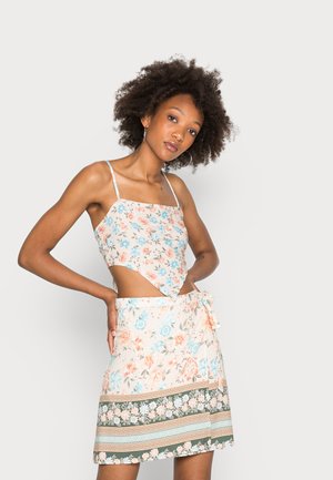 Conjunto de vestido floral com um top quadrado com recorte, alças finas e uma saia com cintura amarrada, padrões florais e detalhes na barra em camadas.