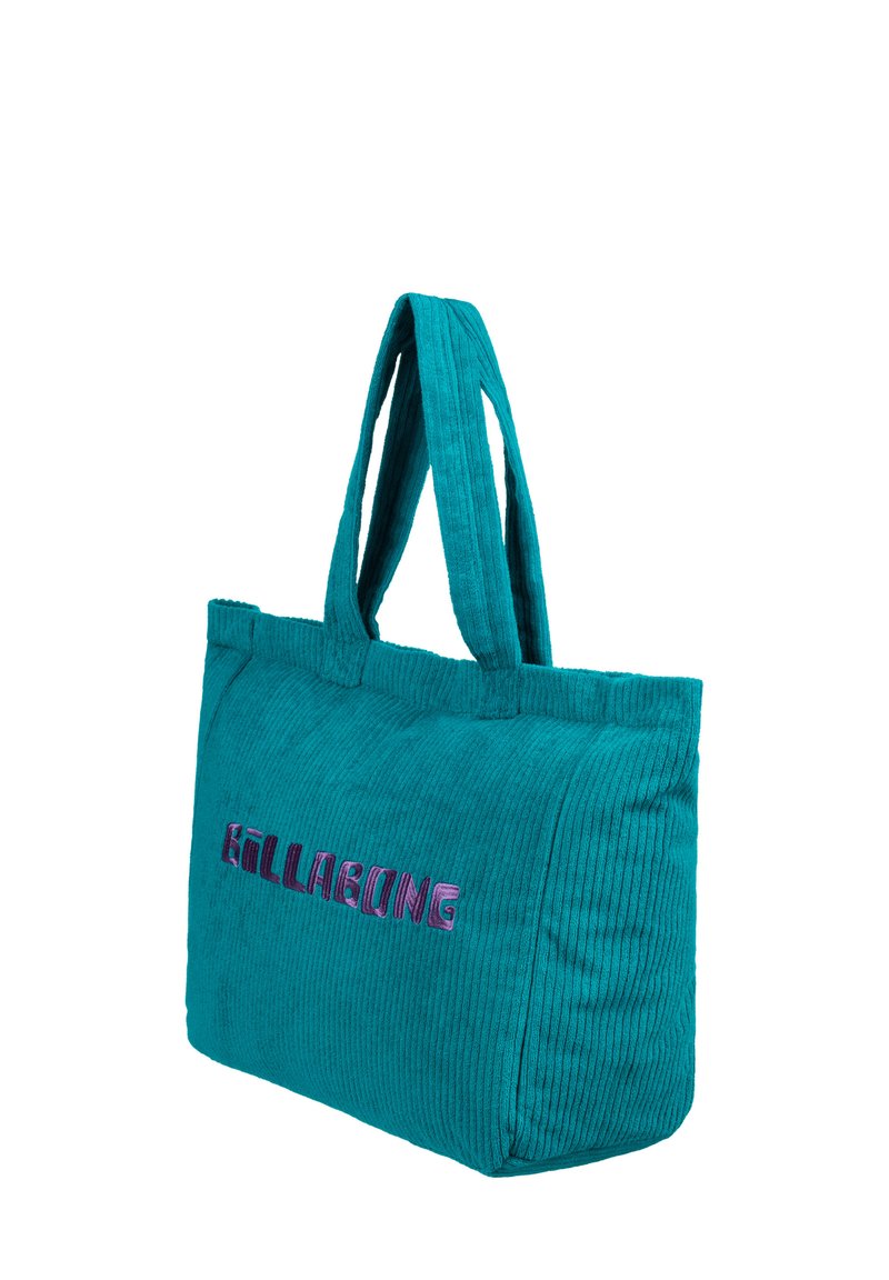 Teal corduroy tote bag with two handles, featuring embroidered "Billabong" logo in pink and purple. Textured surface, rectangular shape.