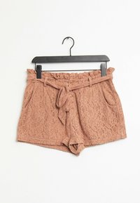 Krajkové šortky v barvě zakouřená růže, s volánovým pasem, zavazovacím páskem a bočními kapsami, s texturovaným květinovým vzorem po celém povrchu.