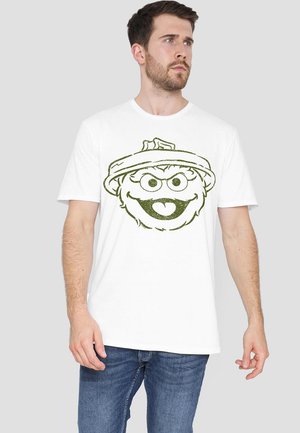 White cotton t-shirt featuring a green graphic of a cartoon character's face with a hat. Short sleeves and crew neck design.