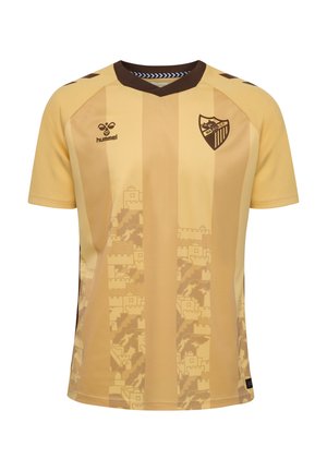 Maillot de football rayé jaune et marron avec le logo Malaga CF sur la poitrine et le logo hummel sur le côté opposé, avec un motif de château sur le devant.