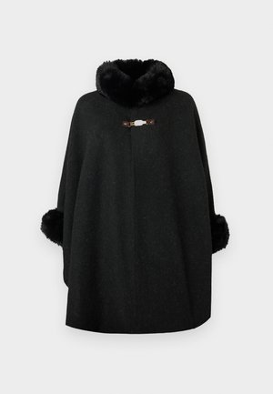 Black poncho made of wool blend fabric with a fluffy collar and fuzzy cuffs. Features a decorative clasp at the front and a seamless design.