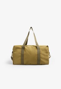 Bolso de lona color caqui con dos asas de tela resistentes, forma cilíndrica, textura suave y cierre de cremallera en un lado.