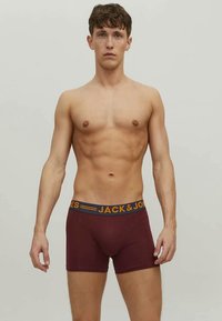 Burgundy boxer briefs with a branded navy waistband, featuring a snug fit and a smooth fabric texture.