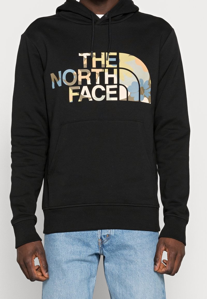 Felpa nera con cappuccio realizzata in morbido tessuto, caratterizzata da un grande logo "The North Face" multicolore con motivi floreali, tasca frontale a marsupio e polsini a coste.