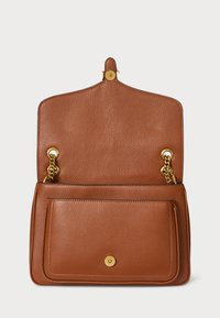 Brown leather handbag with a textured finish, gold hardware accents, and a chain strap. Features a front pocket and button closure.