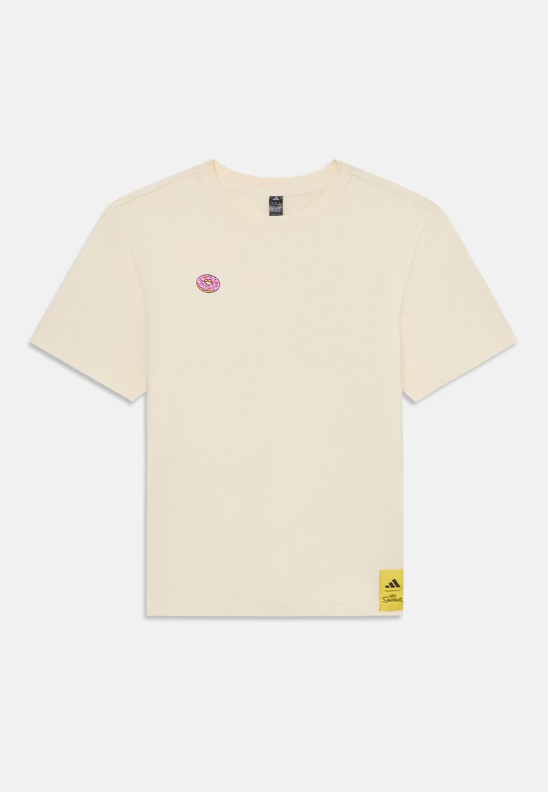 Cremfarbendes Baumwoll-T-Shirt mit kurzen Ärmeln, das ein pinkfarbenes Donut-Logo auf der Brust und ein gelbes Adidas-Etikett am Saum aufweist.