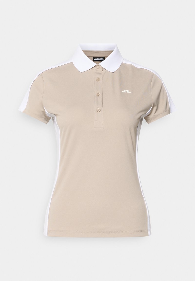 Μπεζ πόλο πουκάμισο με λευκό γιακά και πλαϊνές πάτσες, με τρία κουμπιά και μικρό λογότυπο στο αριστερό στήθος. Ομαλή υφή υφάσματος.