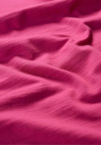 Fuchsia fabric with a soft texture, featuring gentle wrinkles and folds. The material appears lightweight and smooth.