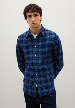 Blue plaid long-sleeve shirt made of woven cotton, featuring a button-down collar, white buttons, and a slightly curved hem.