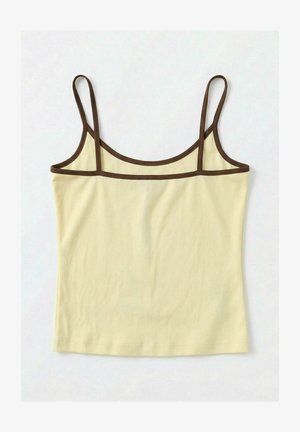Light yellow spaghetti strap tank top with dark brown trim along neckline, straps, and upper edge, laid flat on a white surface.