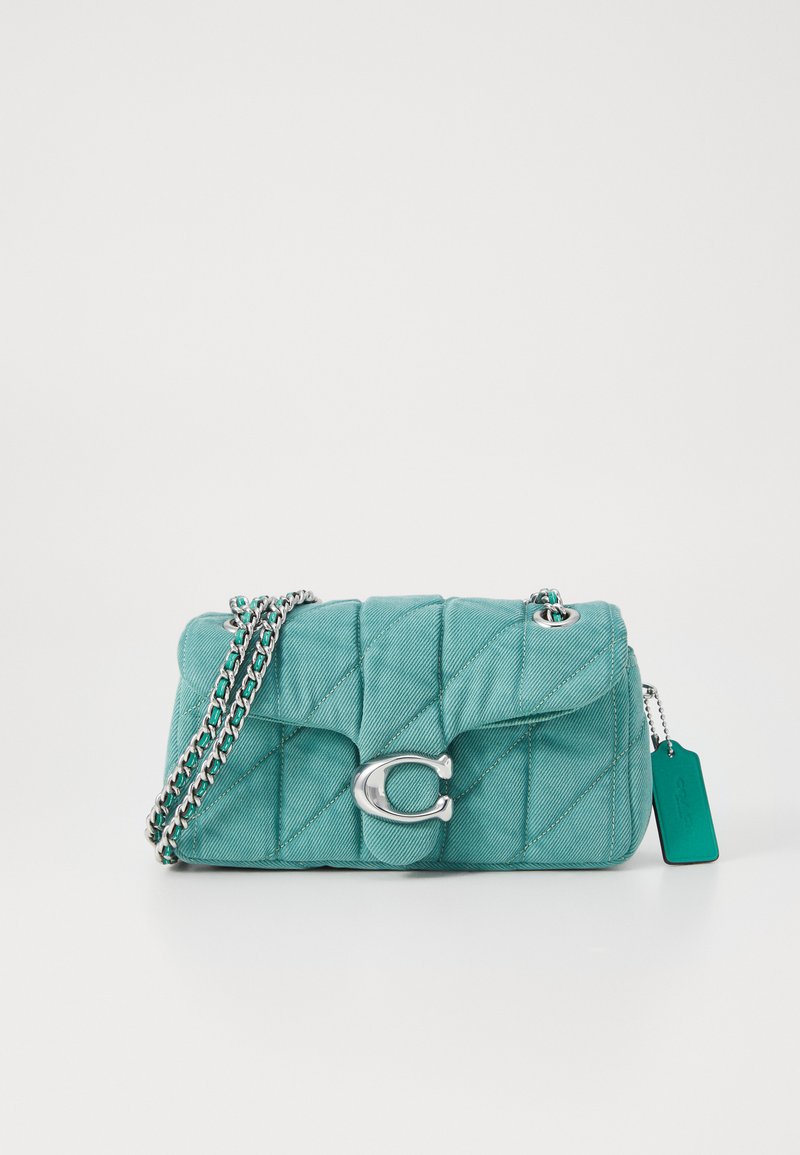 Teal quilted handbag with silver chain strap and clasp, featuring a logo accent and a tag. Smooth texture with diamond pattern.
