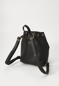 Sac seau noir en matériau synthétique lisse. Doté de quincaillerie dorée, d'une bandoulière ajustable et d'une fermeture en haut par cordon de serrage.
