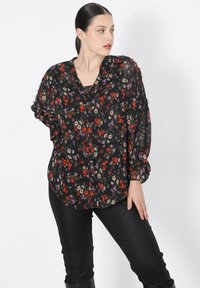 Black floral blouse with red, purple, and white flowers. Lightweight fabric, relaxed fit, button-down front, and long, billowy sleeves.