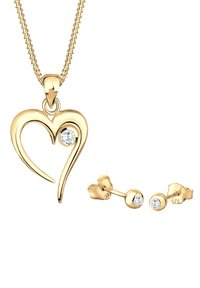 Guldjuvelsset med ett hjärtformat hänge med en kristalldetalj och matchande studearringar med två cirkulära kristaller.