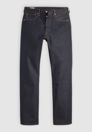 Mörkblå raka denimjeans med orange sömmar, knappslå och femfickdesign ligger platt på ljus bakgrund.