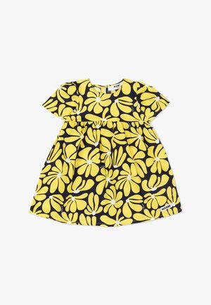 Vestido de manga corta para niño pequeño con fondo negro y grandes flores amarillas con centros blancos, etiqueta "MSGM" en el dobladillo.