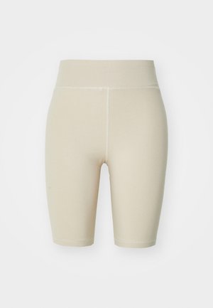 Beige High-Waist-Radshorts aus einem glatten, dehnbaren Material. Sie verfügen über eng anliegende Beine mit dezentem nähen entlang der Nähte.
